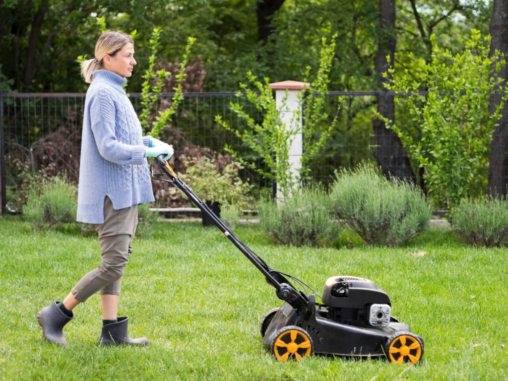 women mowing her yard